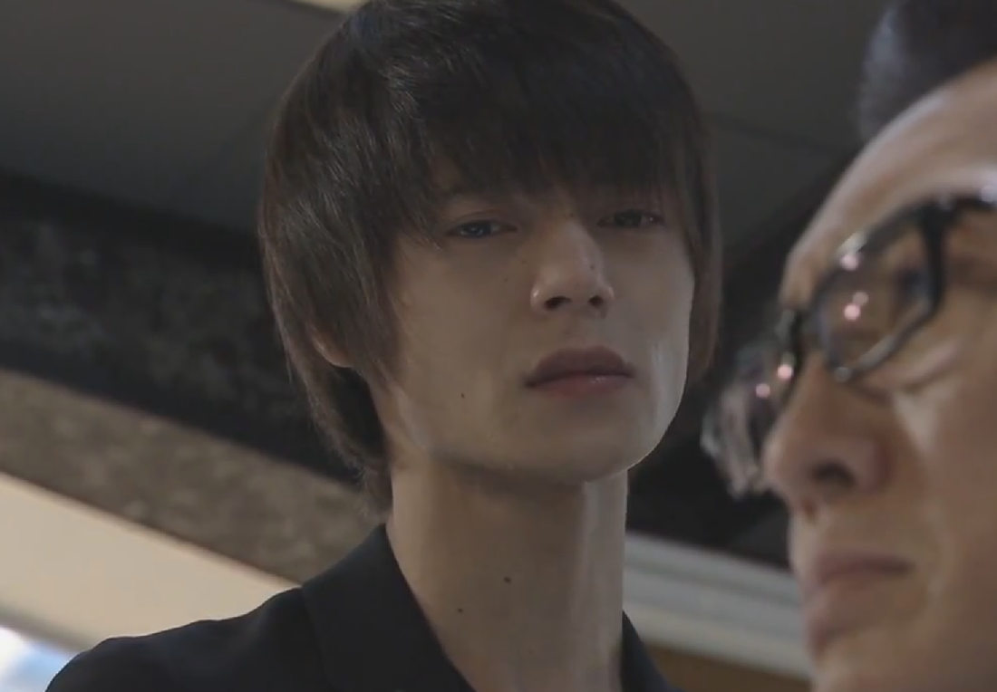 Light Yagami looks at his father pre-detention in Death Note