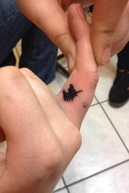 Image: Unicorn finger tattoo